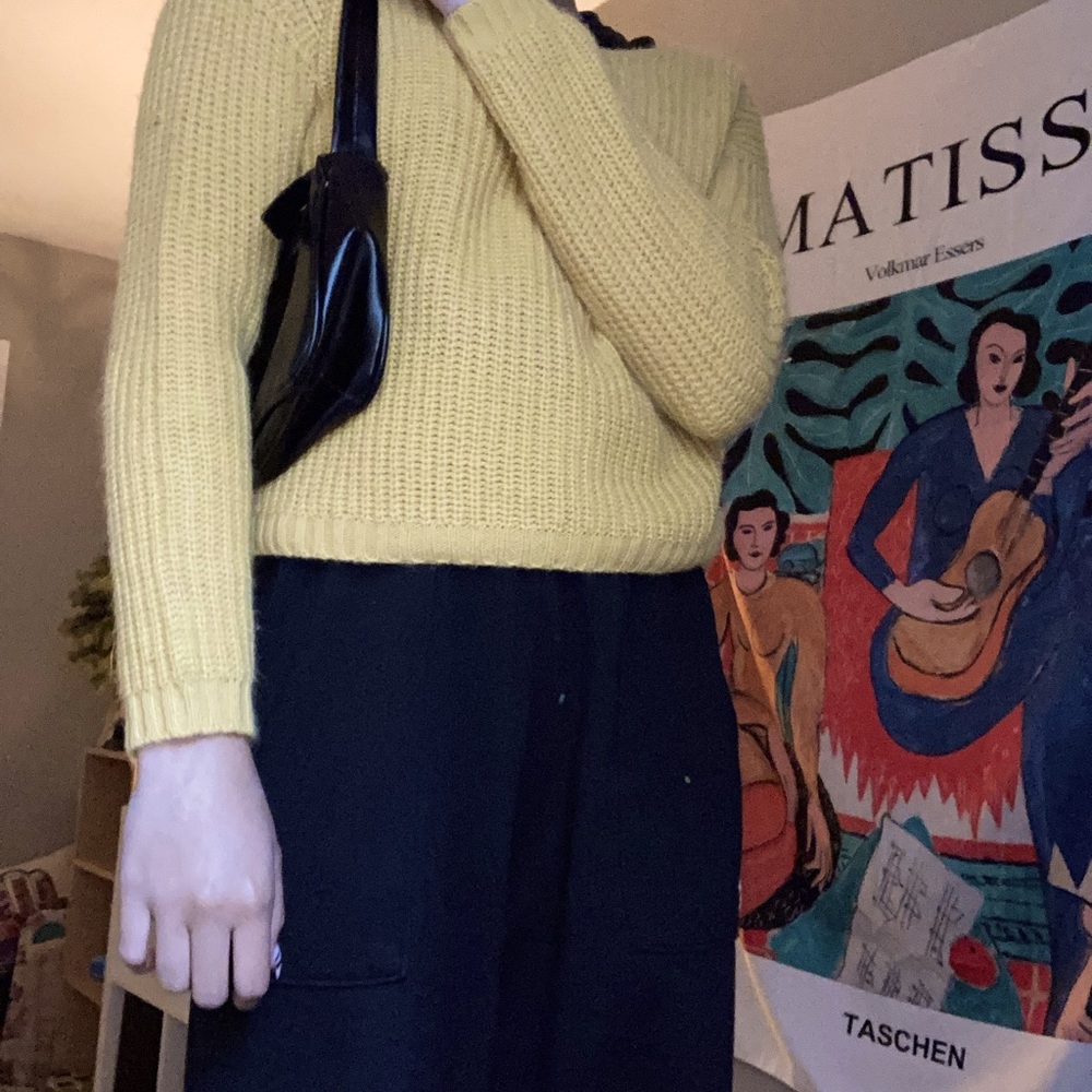 yellowish orange knit sweater with a knot back